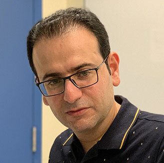 University tech faculty member in glasses and a dark shirt.