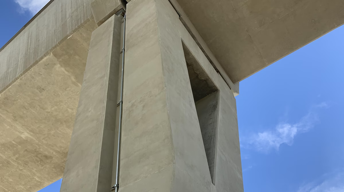 Angle view of a modern concrete structure against a clear blue sky.