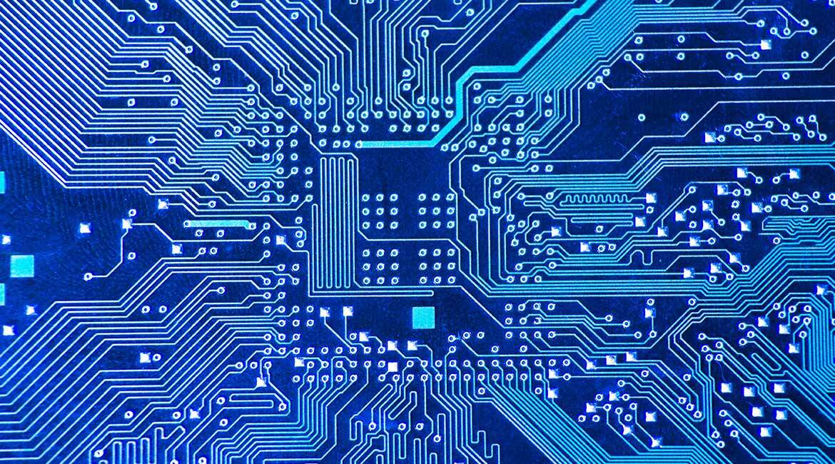 Close-up of a printed circuit board pattern with intricate electrical pathways.