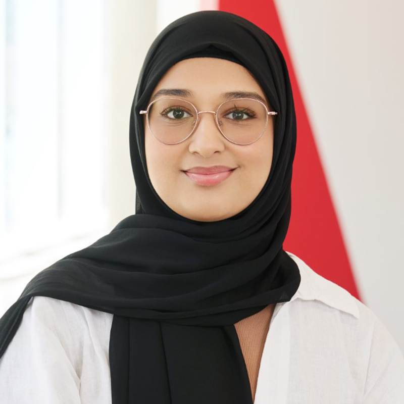 Étudiante souriante en hijab, symbolisant la diversité et l'inclusion dans l'éducation supérieure.