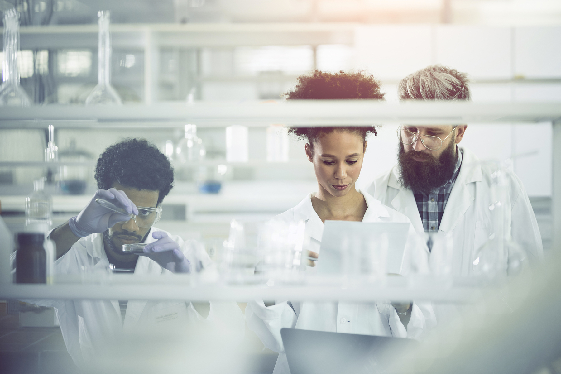 Diverse team of scientists engaged in research in a laboratory setting.